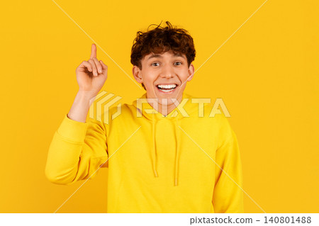 Excited young adult man raising one finger with an idea gesture Excited young adult man raising one finger with an idea gesture 140801488