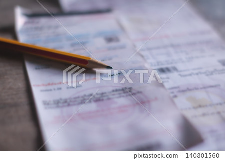 Electricity bill with expense records showing household costs income planning and financial balance. Electricity bill with expense records showing household costs income planning and financial balance. 140801560