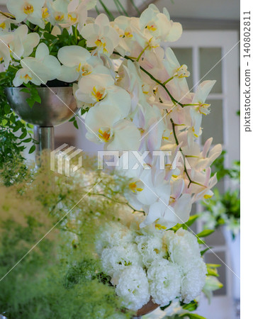 Beautiful flowers from spring to early summer are arranged around the Western-style building, blooming vibrantly in the soft sunlight. Beautiful flowers from spring to early summer are arranged around the Western-style building, blooming vibrantly in the soft sunlight. 140802811