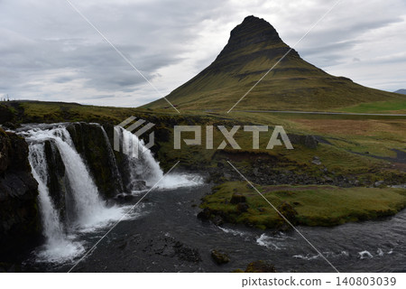 Kirkjufellsfoss waterfall cascading with Kirkjufell mountain in the background, Iceland Kirkjufellsfoss waterfall cascading with Kirkjufell mountain in the background, Iceland 140803039
