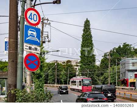 A section of track shared by streetcars and automobiles, and a sign indicating "Passage permitted within the track area." A section of track shared by streetcars and automobiles, and a sign indicating "Passage permitted within the track area." 140803263