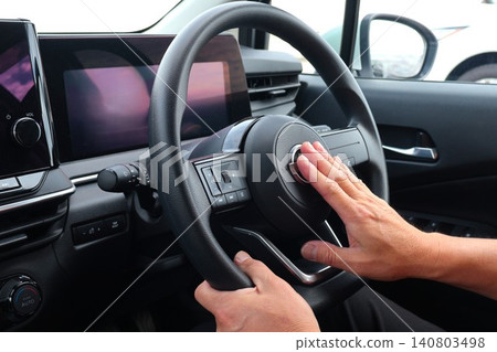 A male driver honks his horn while driving. A male driver honks his horn while driving. 140803498