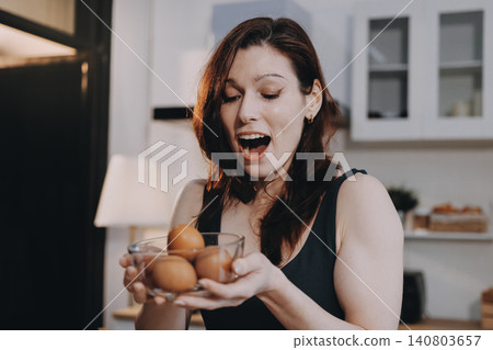Woman preparing green smoothie in bright kitchen with fresh fruits and vegetables, healthy eating lifestyle moment in natural daylight Woman preparing green smoothie in bright kitchen with fresh fruits and vegetables, healthy eating lifestyle moment in natural daylight 140803657