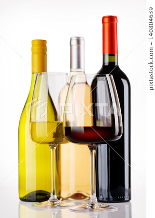 Different wine bottles and glasses on white background Different wine bottles and glasses on white background 140804639