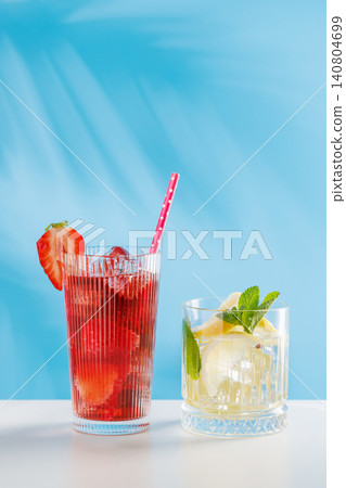 Fresh strawberry and lemon non alcoholic drinks with mint on blue background Fresh strawberry and lemon non alcoholic drinks with mint on blue background 140804699