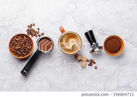 Coffee beans and espresso tools on white marble background Coffee beans and espresso tools on white marble background 140804713