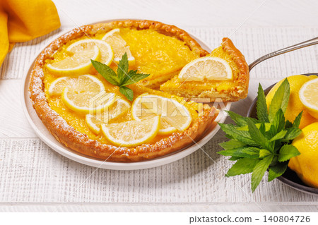 Delicious lemon tart with golden crust and smooth, glossy lemon filling Delicious lemon tart with golden crust and smooth, glossy lemon filling 140804726
