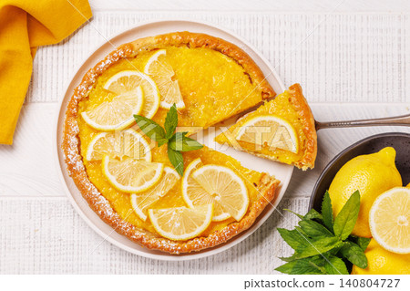 Delicious lemon tart with golden crust and smooth, glossy lemon filling Delicious lemon tart with golden crust and smooth, glossy lemon filling 140804727