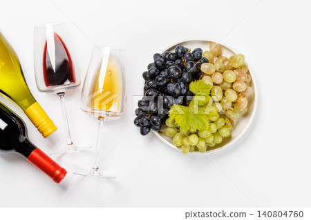 Wine bottle, glasses and bowl of fresh grapes 140804760