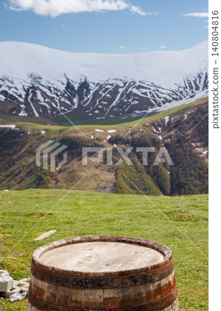 Wooden barrel with mountains in background Wooden barrel with mountains in background 140804816