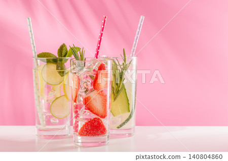Set of fresh non alcoholic drinks with strawberry cucumber and lemon on pink background 140804860