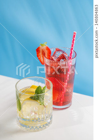 Fresh strawberry and lemon non alcoholic drinks with mint on blue background Fresh strawberry and lemon non alcoholic drinks with mint on blue background 140804863