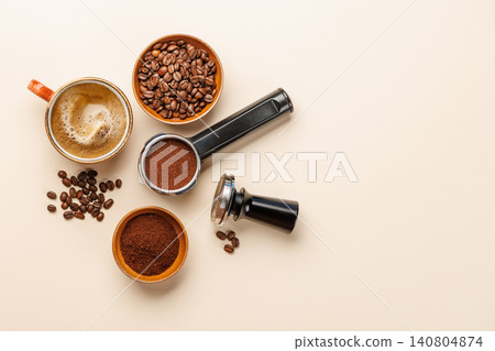 Espresso coffee setup with beans tamper and portafilter top view 140804874