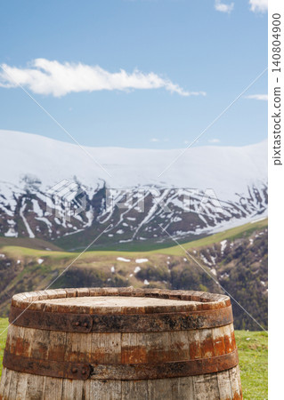 Wooden barrel with mountains in background Wooden barrel with mountains in background 140804900