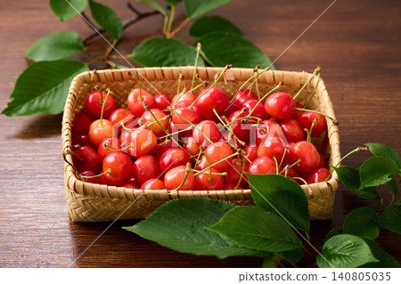 Cherries piled in a basket; Sato Nishiki variety from Yamagata Prefecture. Cherries piled in a basket; Sato Nishiki variety from Yamagata Prefecture. 140805035