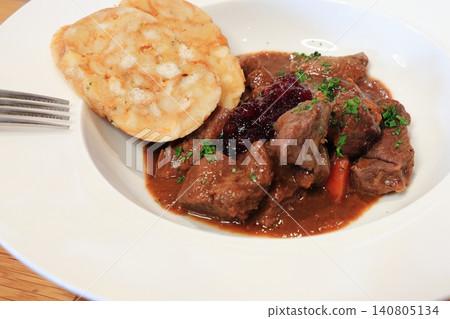A traditional European game dish, Hirschgoulash (venison stew) served with potato dumplings. A traditional European game dish, Hirschgoulash (venison stew) served with potato dumplings. 140805134