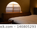 A round window (arched window/half-moon window) and shoji screens, with soft light filtering through them. 140805293