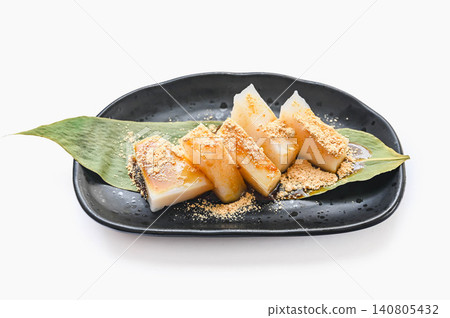 葛粉麻糬盛於竹葉上,淋上黃豆粉和紅糖漿。 葛粉麻糬盛於竹葉上,淋上黃豆粉和紅糖漿。 140805432