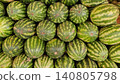 Fresh striped watermelons displayed in busy fruit market 140805798
