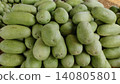 Long light green watermelons on dry grass 140805801