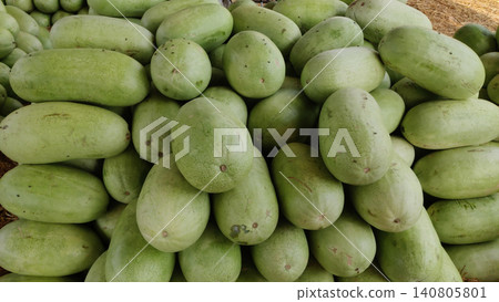 Long light green watermelons on dry grass Long light green watermelons on dry grass 140805801