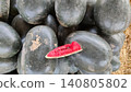 Pakistani watermelon showing whole fruit with single fresh slice 140805802