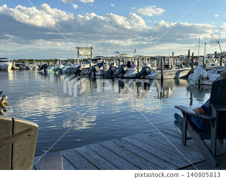 Boats on Water at Marina Under a Blue Sky With Clouds at Golden Hour Boats on Water at Marina Under a Blue Sky With Clouds at Golden Hour 140805813
