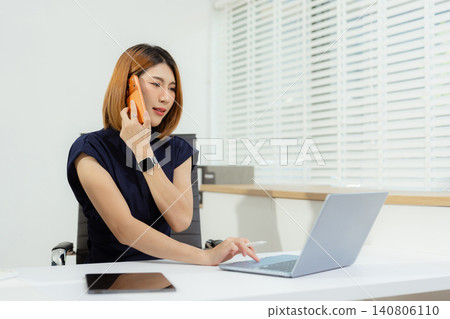Asian businesswoman involved in cellphone call conversation giving professional consultation to client or negotiating project. Asian businesswoman involved in cellphone call conversation giving professional consultation to client or negotiating project. 140806110