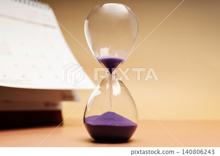 Hourglass beside calendar, time management, aging society and awareness 140806243