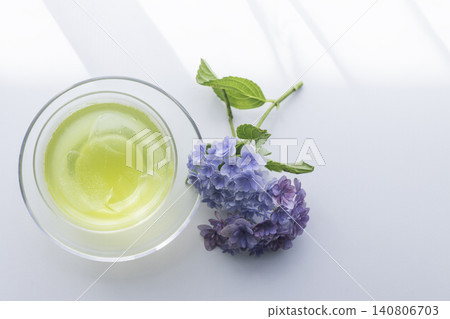 A refreshing table photo featuring hydrangeas taken from above and a cold cup of green tea. A refreshing table photo featuring hydrangeas taken from above and a cold cup of green tea. 140806703