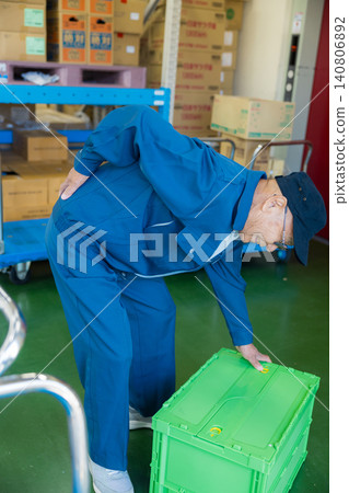 A man working in a warehouse A man working in a warehouse 140806892