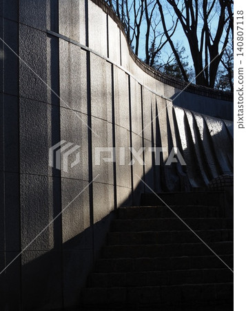 A modern exterior wall illuminated by the strong afternoon sun. 140807118