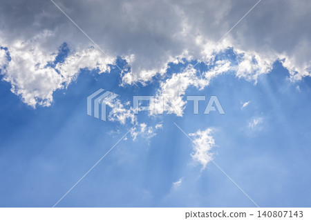 Sunbeams breaking through clouds in blue sky Sunbeams breaking through clouds in blue sky 140807143