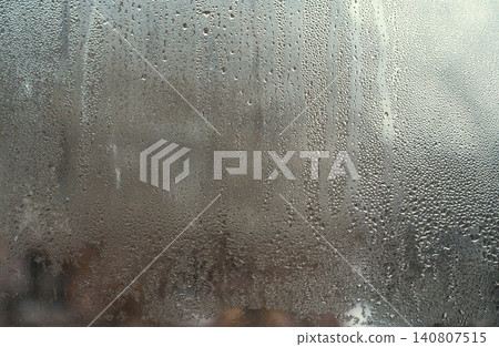 wet glass, drops on window. condensation droplets pattern interior glass. glass abstract background. fogged window inside apartment, increased humidity, cold condensation on window wet glass, drops on window. condensation droplets pattern interior glass. glass abstract background. fogged window inside apartment, increased humidity, cold condensation on window 140807515
