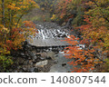 A small waterfall ablaze with autumn colors. 140807544