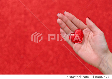 a heart in a woman's hand. concept of love a heart in a woman's hand. concept of love 140807577