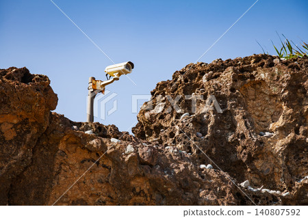 CCTV security camera on rocky wall CCTV security camera on rocky wall 140807592