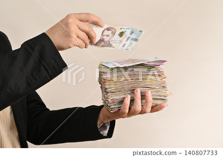 Individual embraces thick stacks of cash, symbolizing prosperity, Individual embraces thick stacks of cash, symbolizing prosperity, 140807733