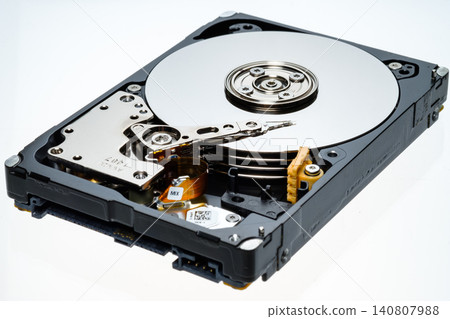 a computer's hard disk HDD data storage drive without a shield isolated in a white background shows magnetic disc and electronic parts inside a computer's hard disk HDD data storage drive without a shield isolated in a white background shows magnetic disc and electronic parts inside 140807988