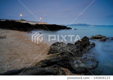 a twilight sky on the beach with many rocks, shot with low speed of shutter a twilight sky on the beach with many rocks, shot with low speed of shutter 140808125
