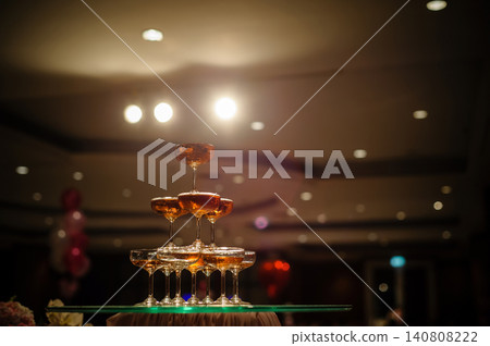 small tower of champagne's glass in wedding reception party small tower of champagne's glass in wedding reception party 140808222