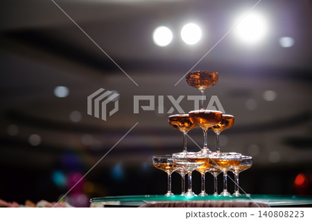 small tower of champagne's glass in wedding reception party small tower of champagne's glass in wedding reception party 140808223