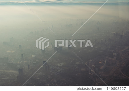 Bangkok city's bird eye view shot from a plane that flight in a morning with warming color of sunrise and some shade from clouds photo may had some noise and partly blur Bangkok city's bird eye view shot from a plane that flight in a morning with warming color of sunrise and some shade from clouds photo may had some noise and partly blur 140808227