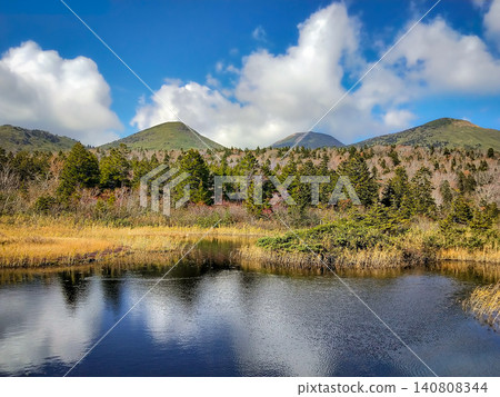 Mount Odake, Mount Kodake, and Mount Ioudake as seen from Suiren-numa Pond in Hakkoda Mountains in October; the autumn wetland scenery reflected on the water's surface. Mount Odake, Mount Kodake, and Mount Ioudake as seen from Suiren-numa Pond in Hakkoda Mountains in October; the autumn wetland scenery reflected on the water's surface. 140808344
