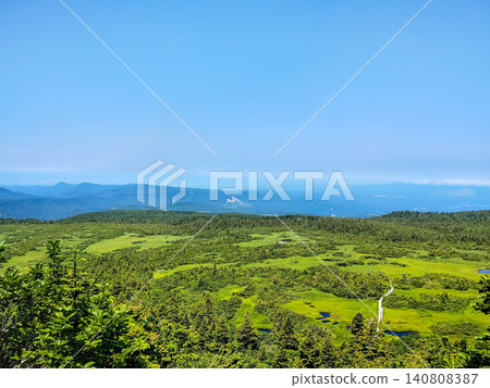 A view of the summer high-altitude wetlands from Kenashidai in the Hakkoda Mountains in July: sparkling ponds and endless boardwalks. A view of the summer high-altitude wetlands from Kenashidai in the Hakkoda Mountains in July: sparkling ponds and endless boardwalks. 140808387