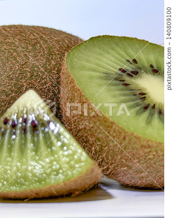 Juicy kiwi fruit slice close-up on white. 140809100