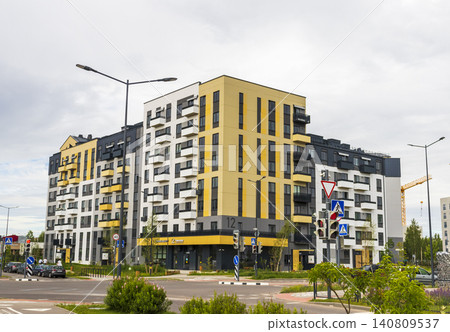 MINSK, BELARUS - JUNE 24, 2026: Modern scandinavian-style cityhouses and contemporary apartment block architecture in the suburban residential complex Zelena Gavan near Kolodishchi on a cloudy day. MINSK, BELARUS - JUNE 24, 2026: Modern scandinavian-style cityhouses and contemporary apartment block architecture in the suburban residential complex Zelena Gavan near Kolodishchi on a cloudy day. 140809537