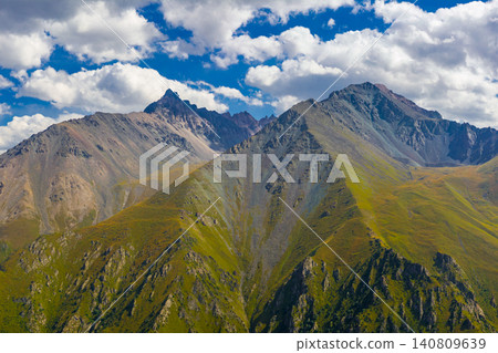 Majestic Mountain Range in Kyrgyzstan Under Blue Sky Majestic Mountain Range in Kyrgyzstan Under Blue Sky 140809639