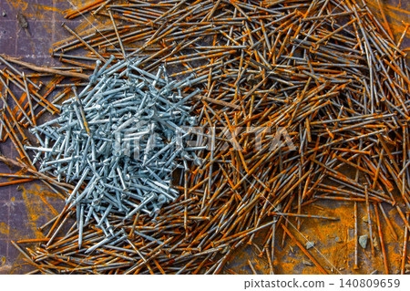 Contrast of New and Rusty Nails on Dark Surface Contrast of New and Rusty Nails on Dark Surface 140809659