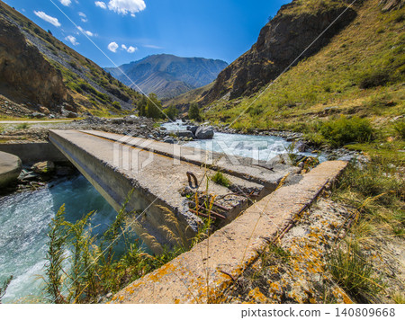 Damaged Concrete Bridge Over Turquoise River in Kyrgyzstan Damaged Concrete Bridge Over Turquoise River in Kyrgyzstan 140809668